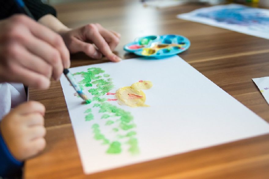 Children paint with watercolors.